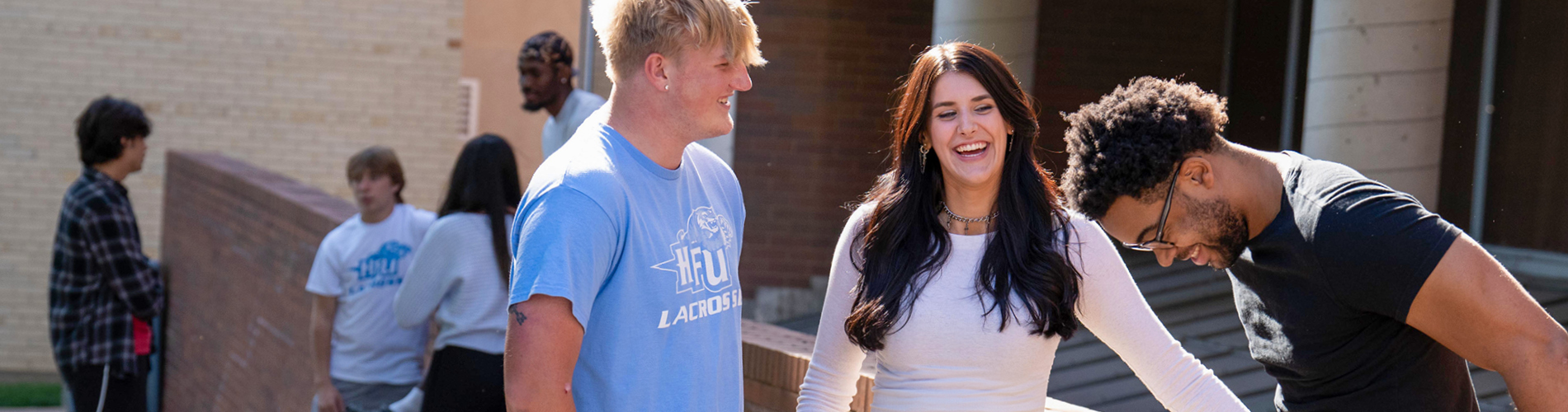 Several undergraduate students talking and hanging out on Holy Family University's campus