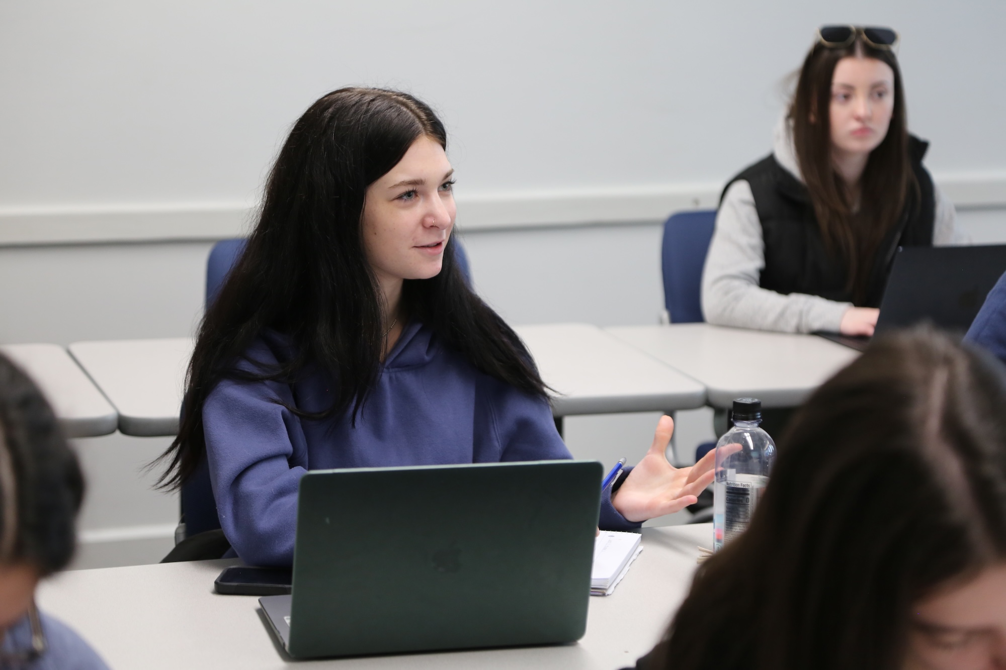 HFU student sitting and speaking in class