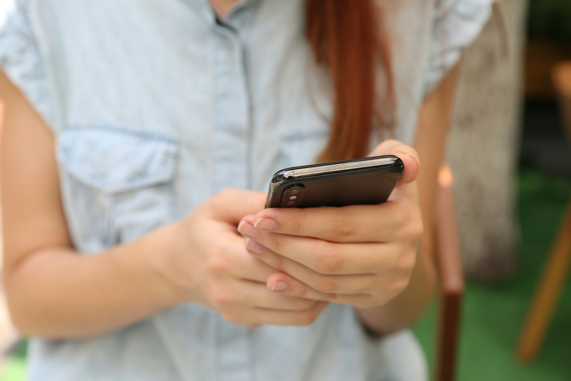 Close up of female student using a smartphone