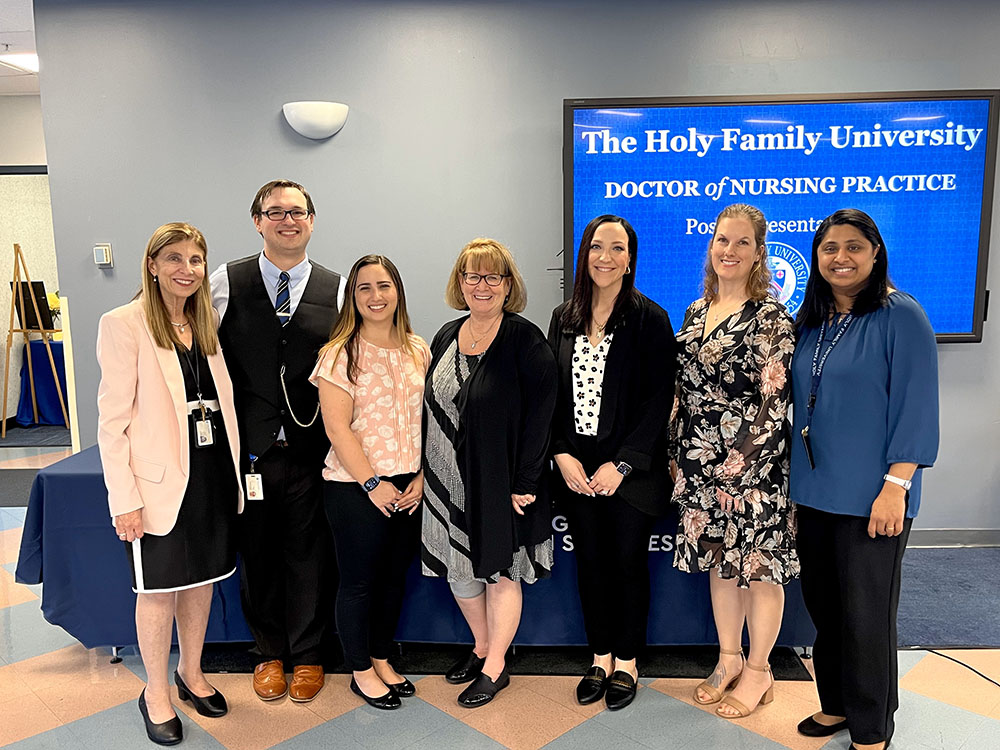 Doctor of Nursing Practice students and professors at poster event