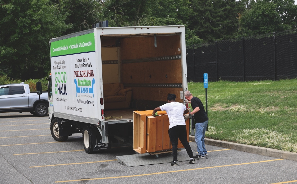 Two HFU employees loading furniture into a truck