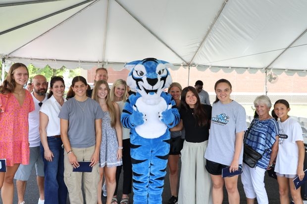 HFU students and parents with HFU's mascot Blue