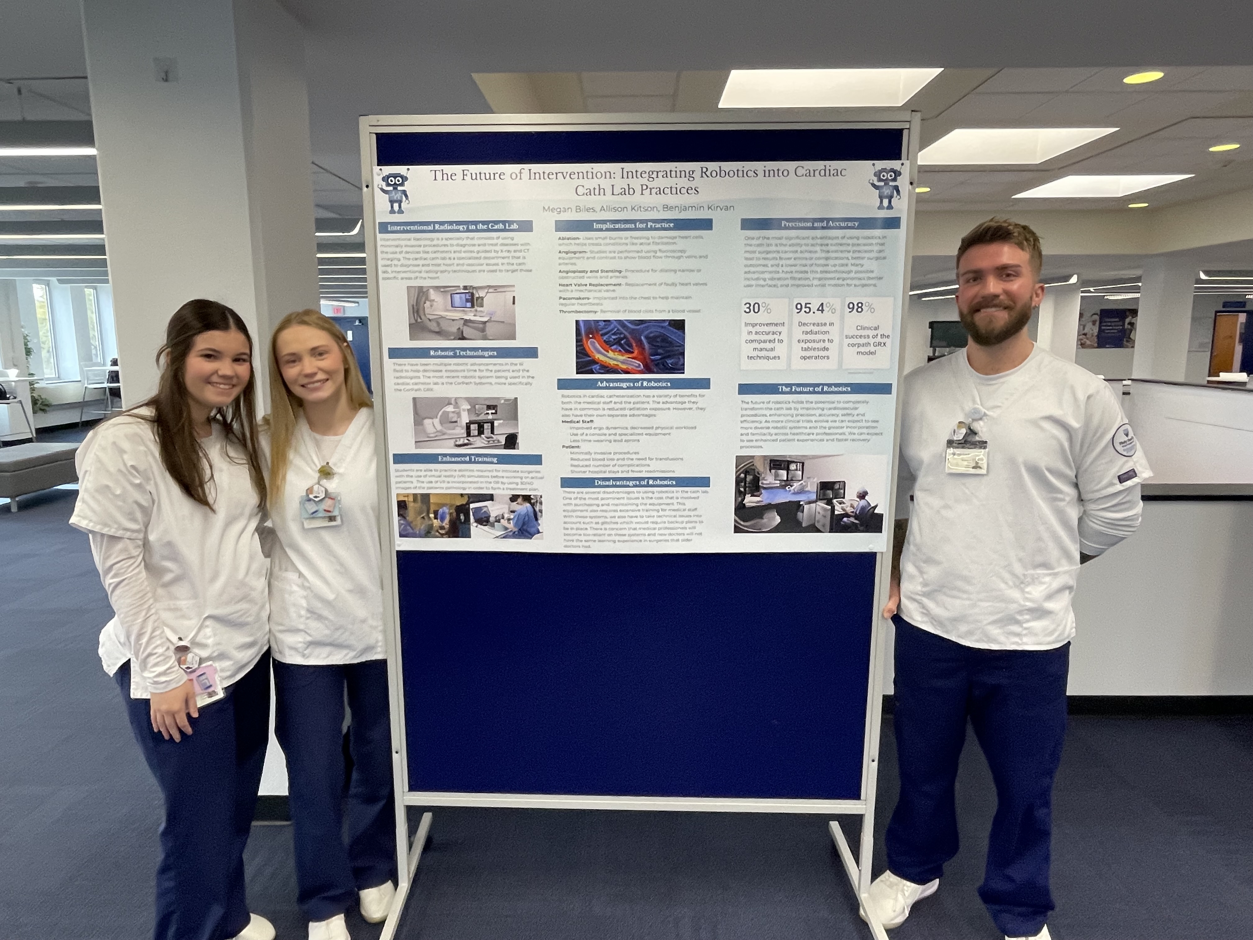 Students present poster on use of robotics in cath lab.