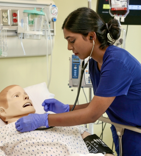 Holy Family University nursing student working in the simulated patient lab