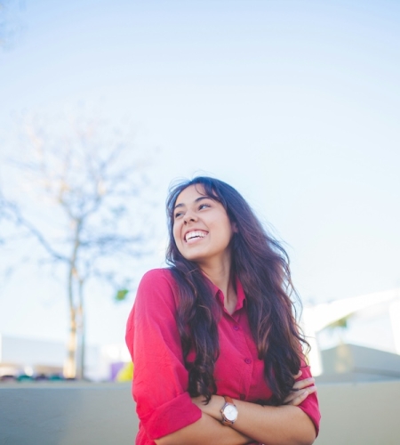 Female college student smiling outdoors on campus