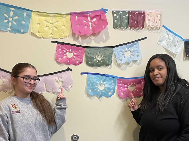 Two HFU Spanish students posing with the classes work