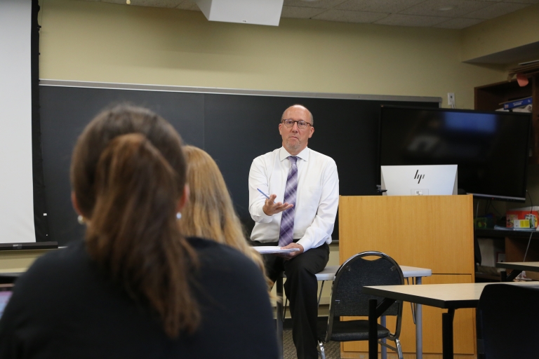 Faculty member lecturing to students in a Holy Family classroom